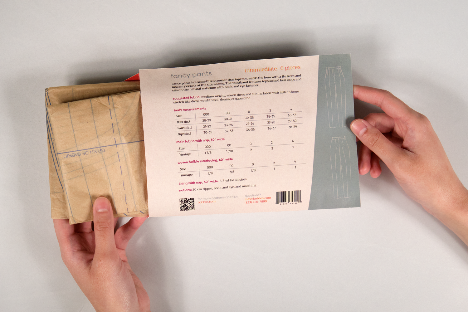 Hand taking pattern out of envelope