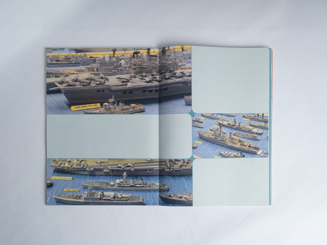 Book spread with miniature ships