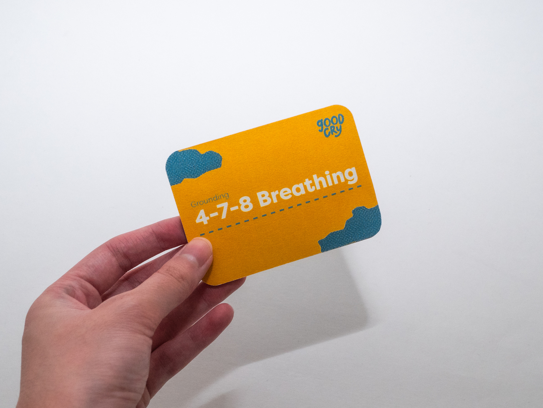 Hand holding yellow card again