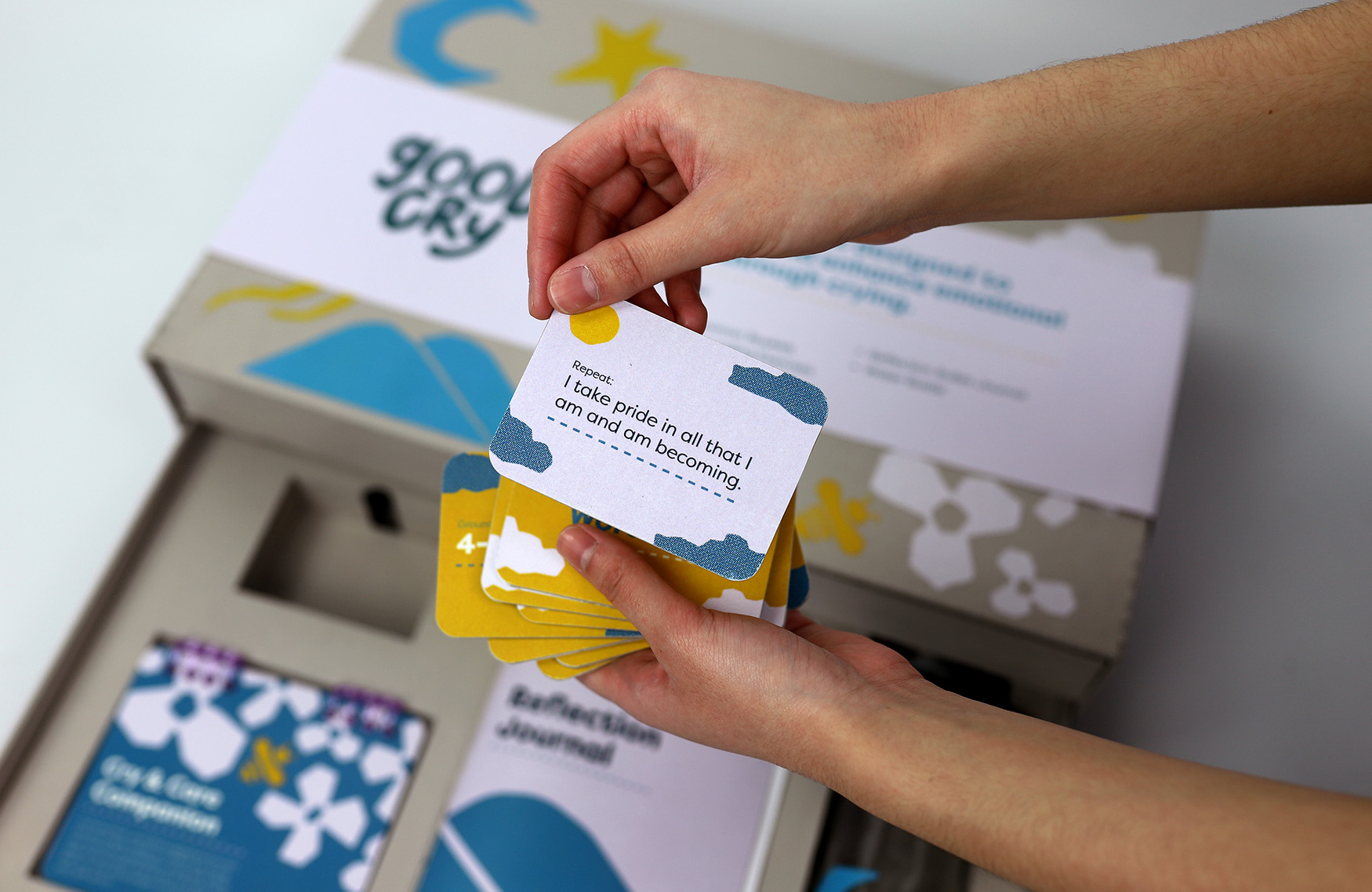 Hands grabbing cards outside of box