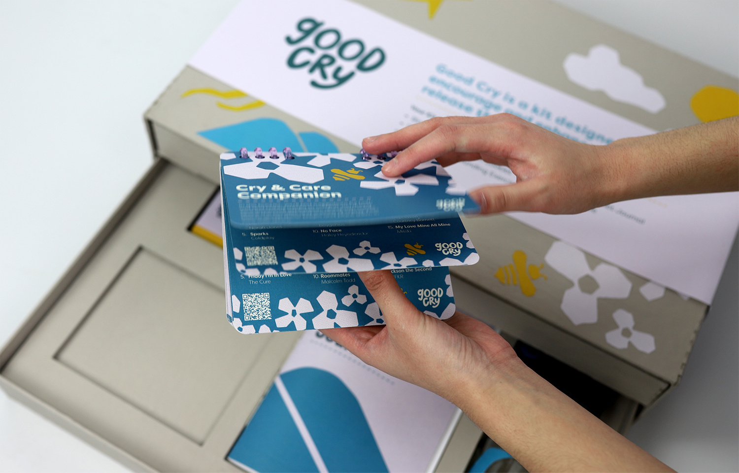 Hand flipping through book outside of box